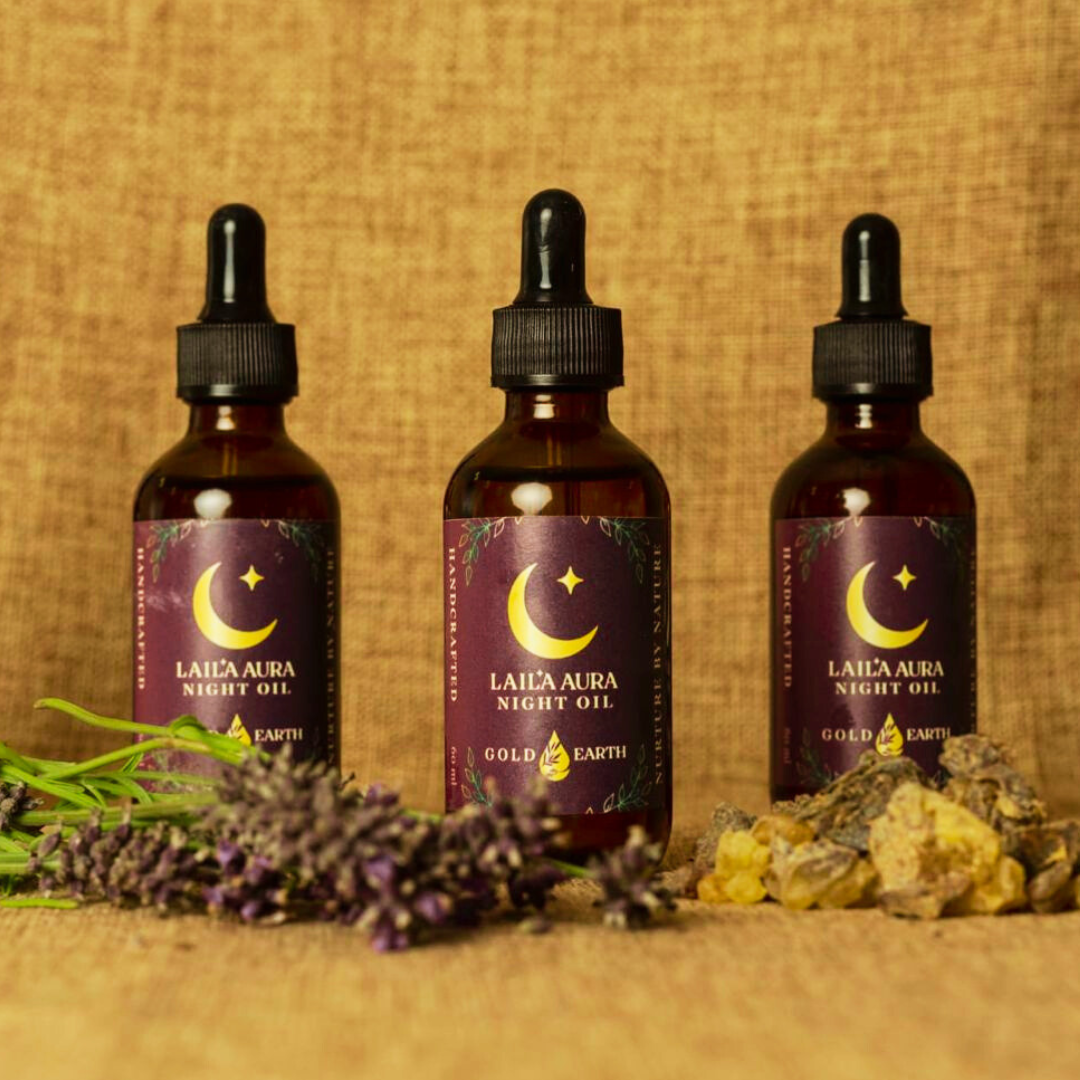 Laila Aura Night Oil bottles arranged with lavender and natural stones on a textured background.